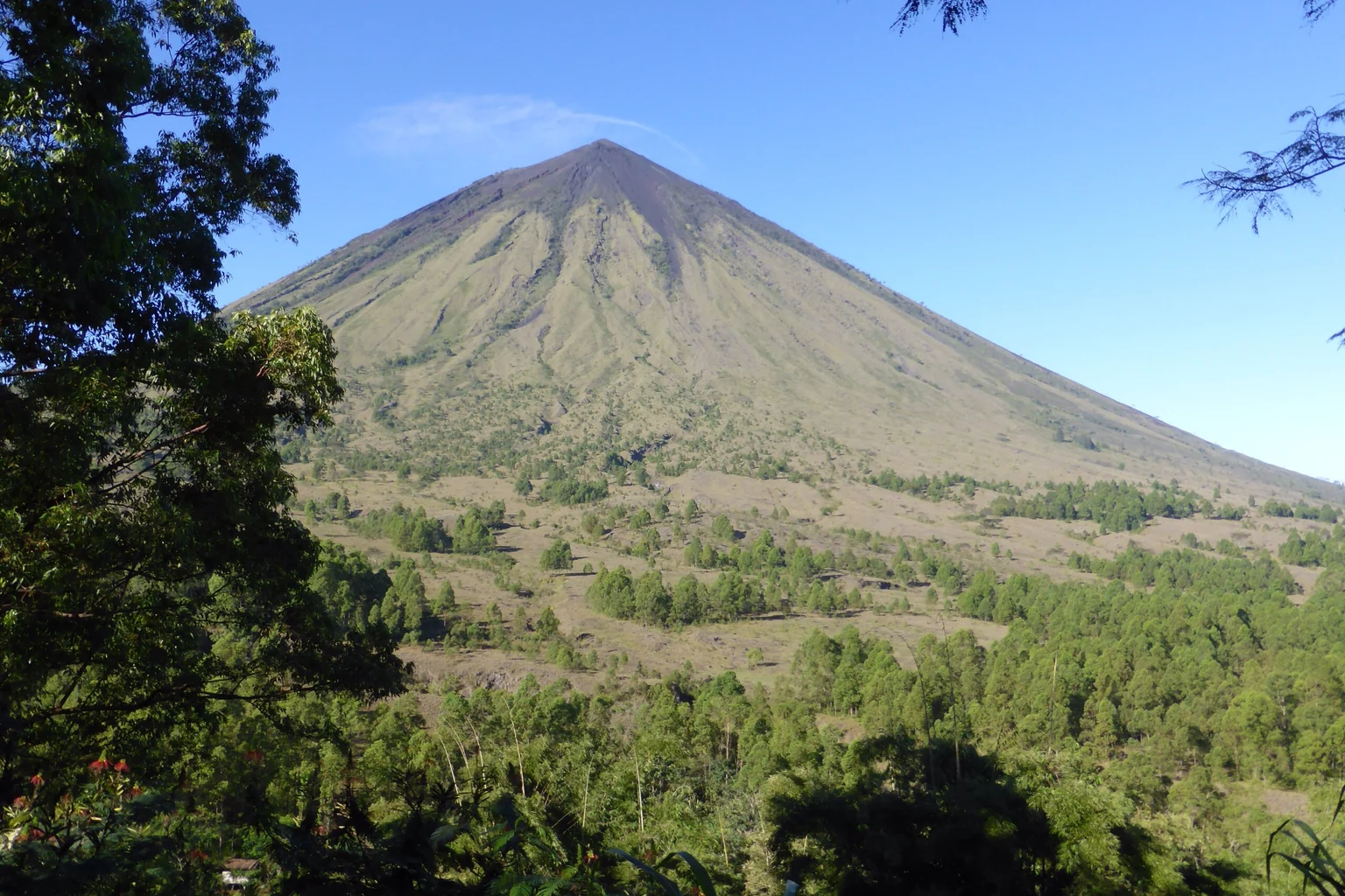 El monte Inerie, un cono volcánico de 2.245 metros de altura que se eleva sobre Bajawa, en el centro de Flores, con sus laderas superiores desnudas y cubiertas de pedregal que se alzan por encima de la sabana y los árboles dispersos