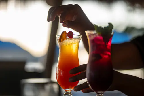 Cocktails raised against the Komodo sunset