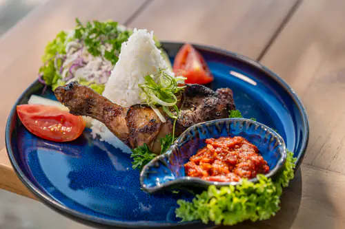 Mixed grill platter with rice and fresh garnishes