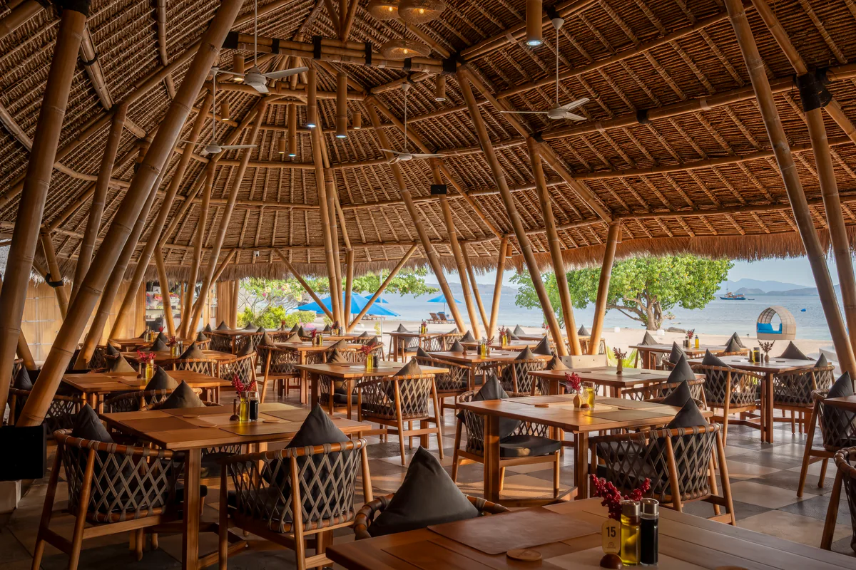 Open-air bamboo Sunset Restaurant on the beach at Komodo Resort