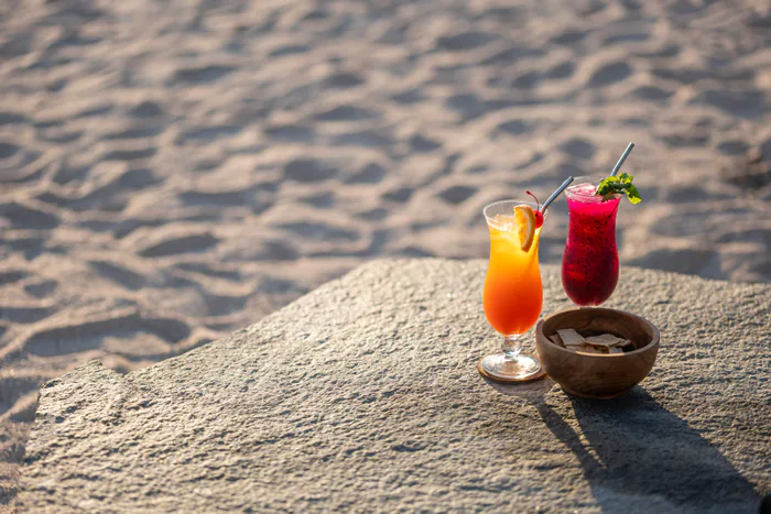 Cocktails on the sand at sunset