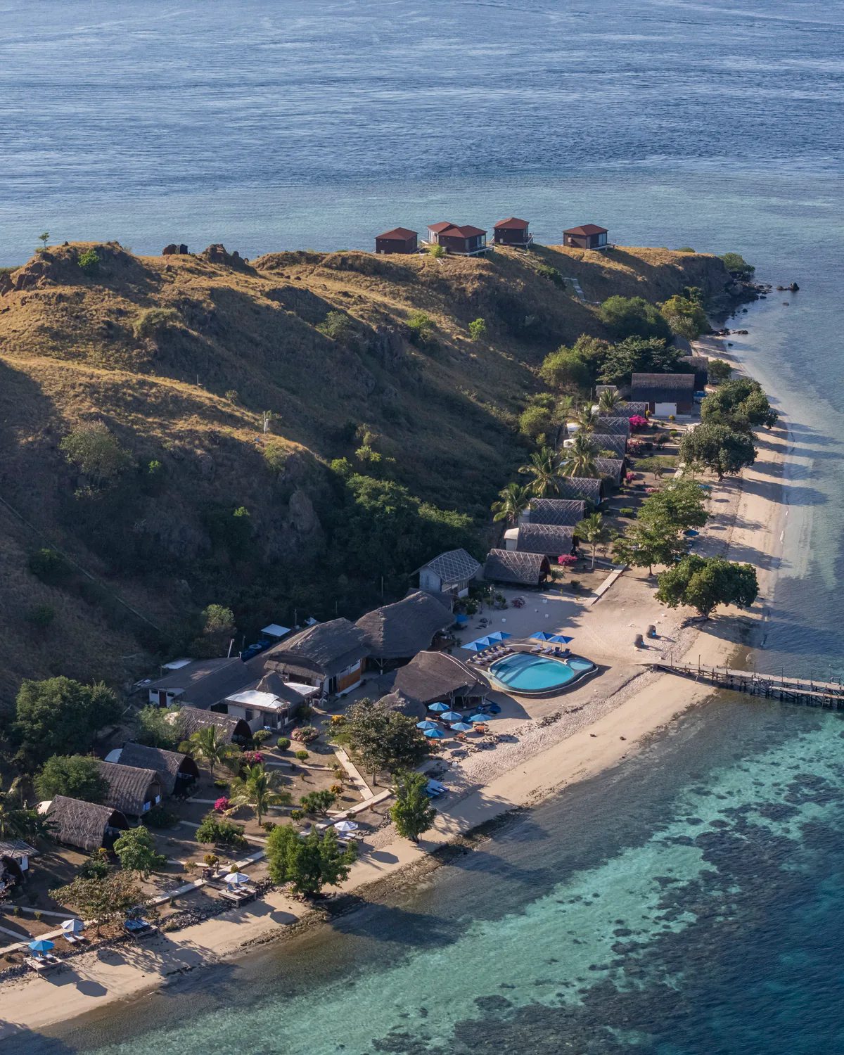 Komodo Resort bungalows, jetty and house reef seen from the air