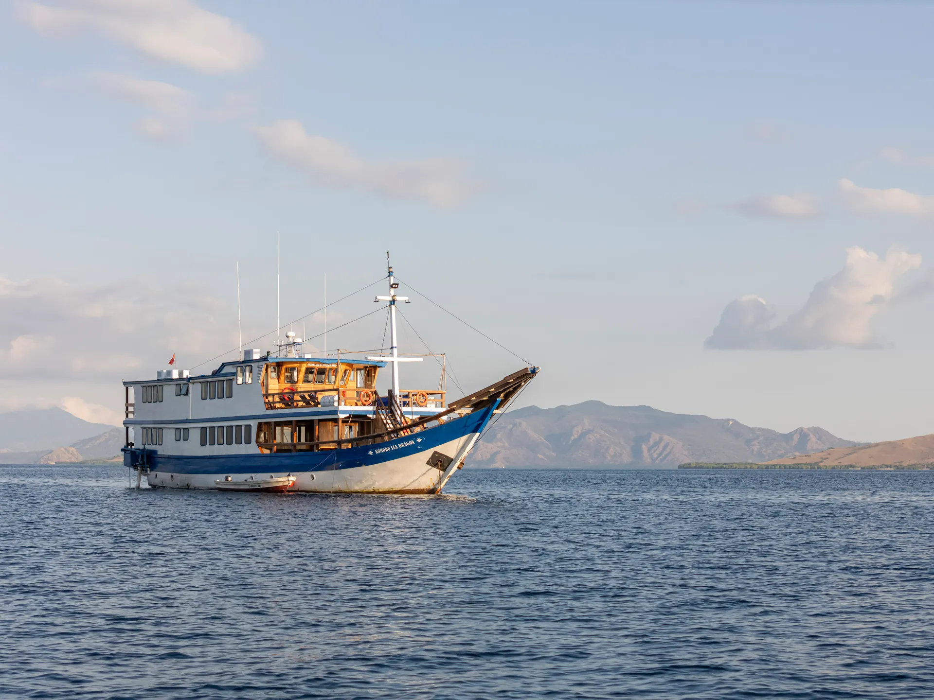 Komodo liveaboard sailing through turquoise waters in Komodo National Park