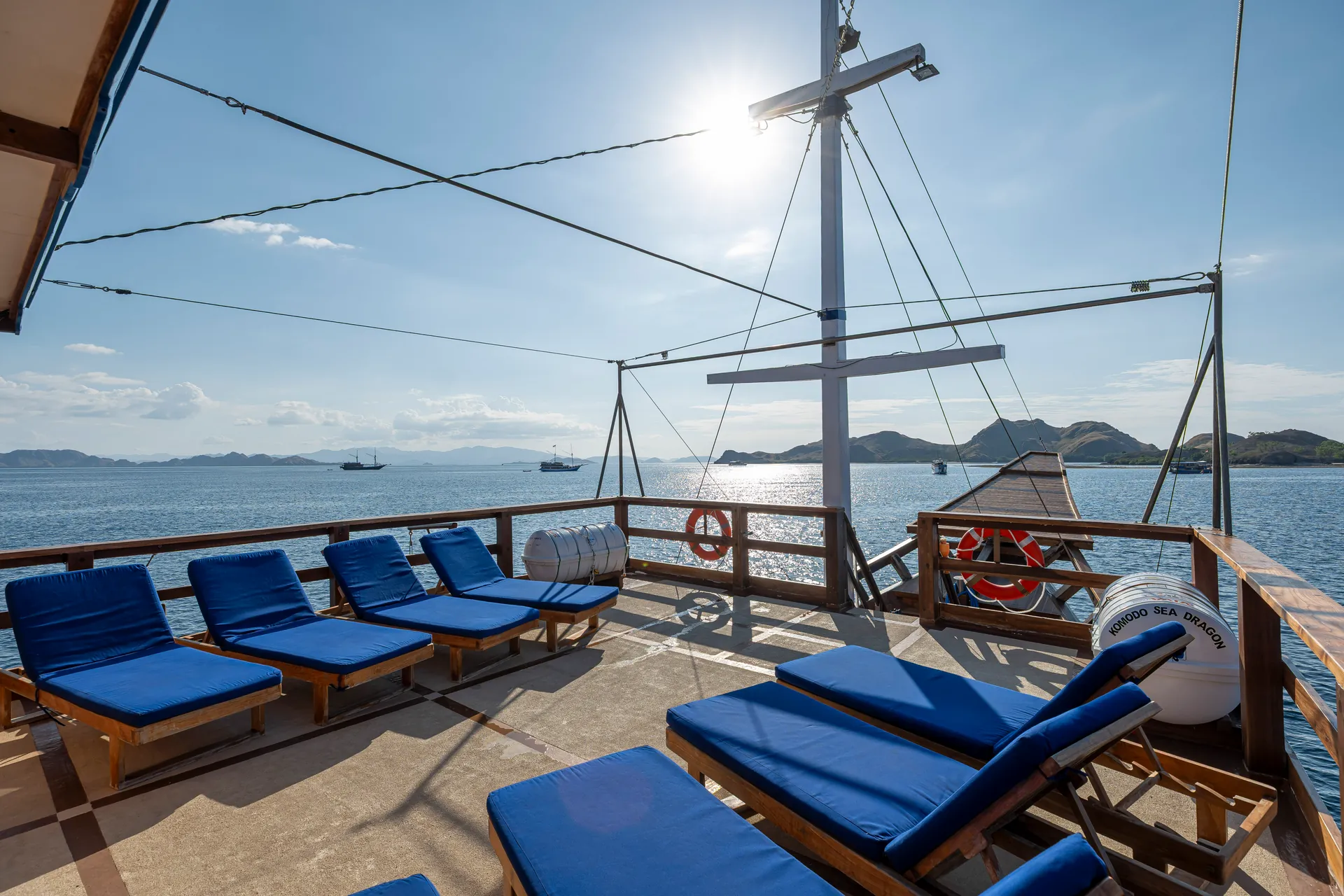 Shaded sun deck loungers aboard the Komodo Sea Dragon liveaboard