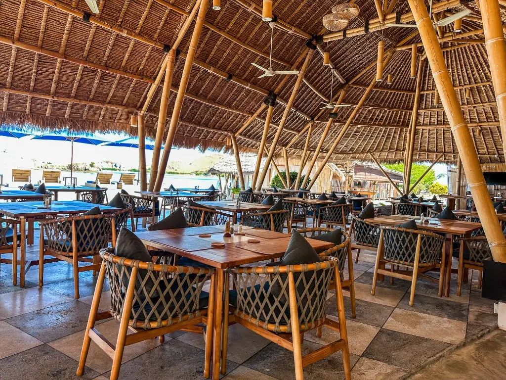 Open-air bamboo Sunset Restaurant with ocean view at Komodo Resort